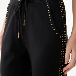 Pantalon noir à œillets